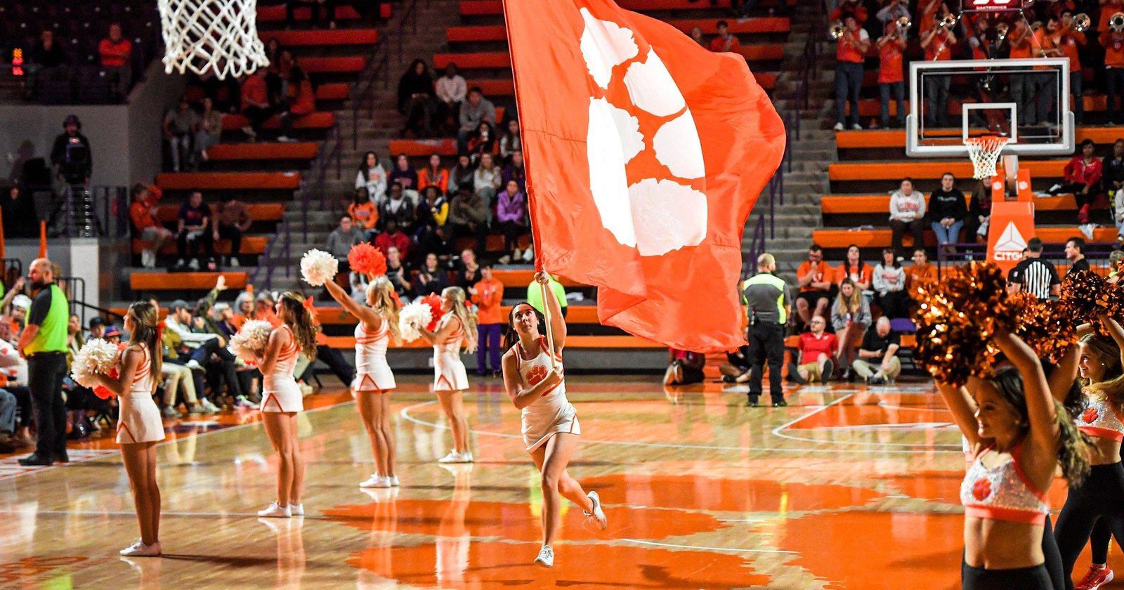 A Clemson cheerleader runs a flag by other cheerleaders during the second half at Littlejohn Coliseum Thursday, November 21, 2024; Clemson, SC, USA. (© Ken Ruinard - staff / USA TODAY NETWORK via Imagn Images)